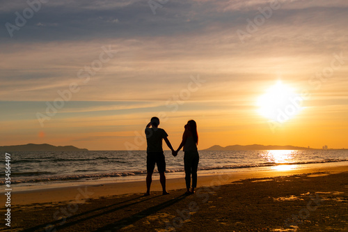 Couple sweet are walking for relax on the beach on the sunshine 