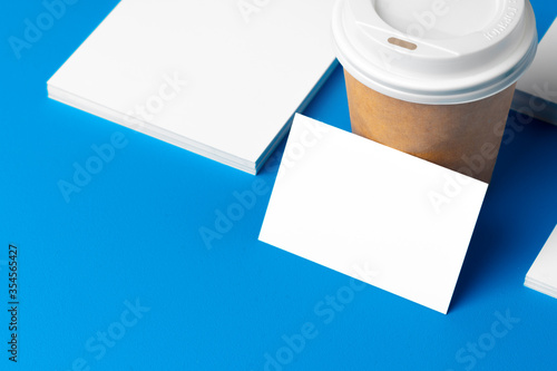 Blank takeaway coffee cup and white businesscards photo