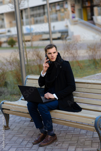 Young man on the street and in cafe with mobile phone, computer.