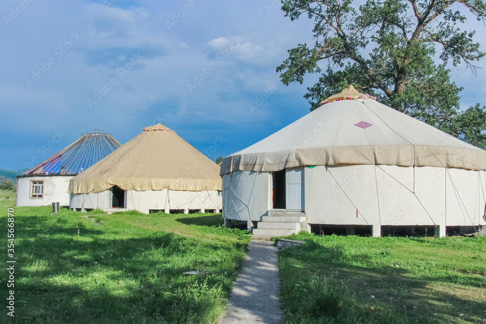 A row of traditional constructed yurts in Kalajun Grassland, Xinjiang, China
