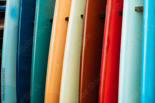 Set of colorful surfboard for rent on the beach. Multicolored blue, red, white surf boards different sizes and colors surfing boards on stand, surfboards rental place