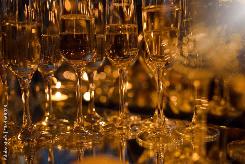 Glasses with champagne on the table, different focus, warm brown tinted