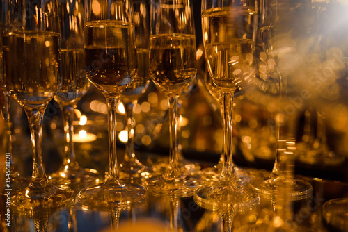 Glasses with champagne on the table, different focus, warm brown tinted