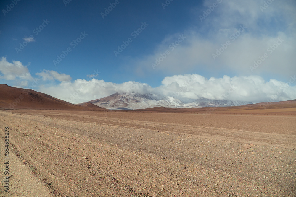Landscape mountain Water Lake. Dry, Barren desert, snowcapped mountains wilderness. Mountain range view. Salt Flats, Uyuni, Bolivia. Copy space, Rocks, blue sky, nature, hiker, hiking