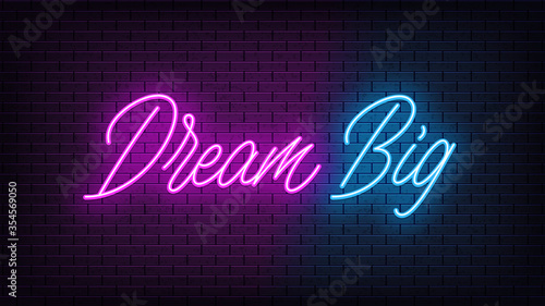Neon Dream Big, lettering. Neon text of Dream Big on black brick background
