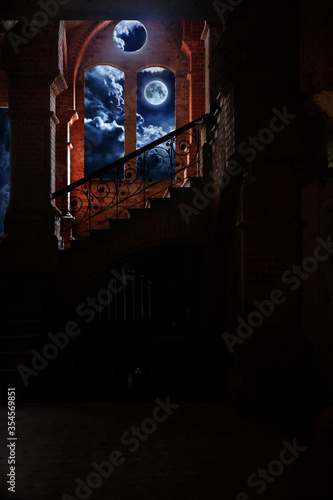 Fairy tale inside castle ruins at night against the background of the full moon