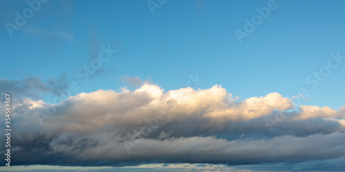 Low altitude stratocumulus cloud under a blue sky, panoramic nature background