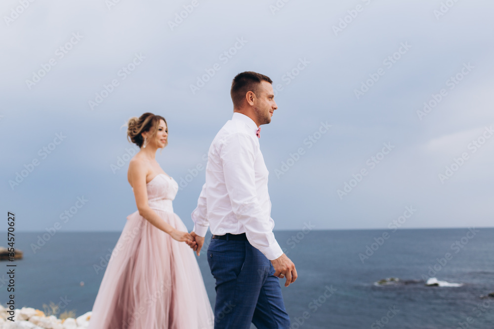Loving couple on the seashore. Wedding. Newlyweds. Loving couple on the seashore. Wedding. Newlyweds.