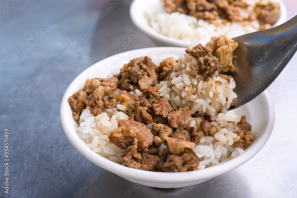 Braised meat rice, stewed beef over cooked rice in Tainan, Taiwan. Taiwanese famous traditional street food delicacy. Travel design concept, closeup. Braised meat rice, stewed beef over cooked rice in Tainan, Taiwan. Taiwanese famous traditional street food delicacy. Travel design concept, closeup.