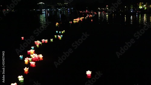 Glowing lanterns floating on the river  in the Hoi An  city, Vietnam