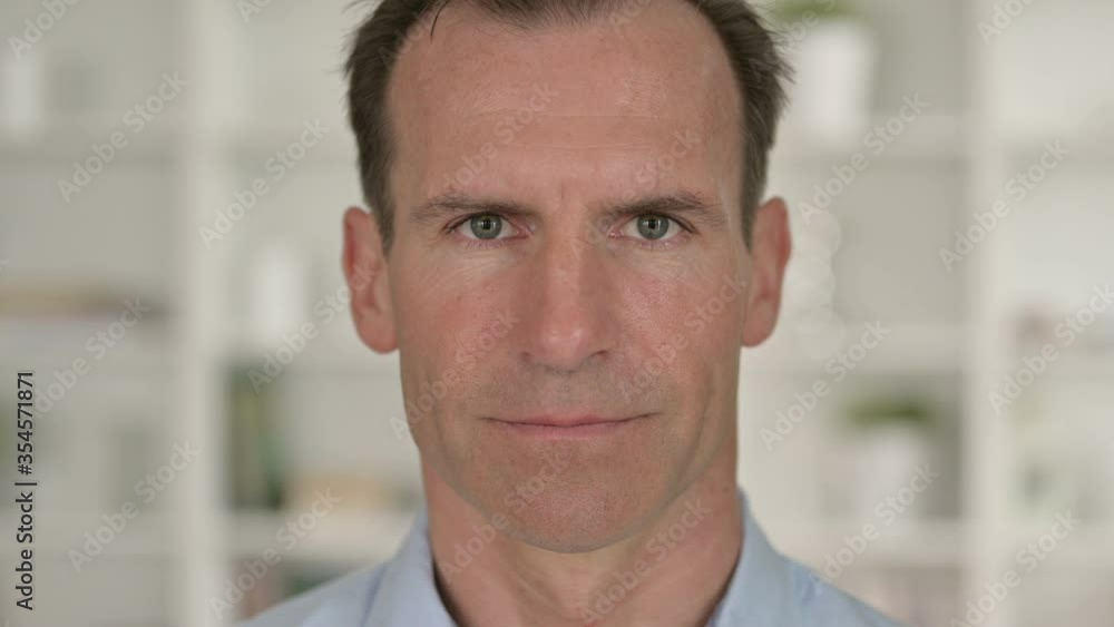 Close Up of Serious Middle Aged Businessman Looking at Camera Close Up of Serious Middle Aged Businessman Looking at Camera