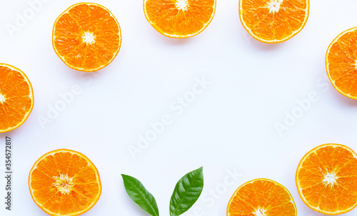 Frame made of orange fruit on white background.