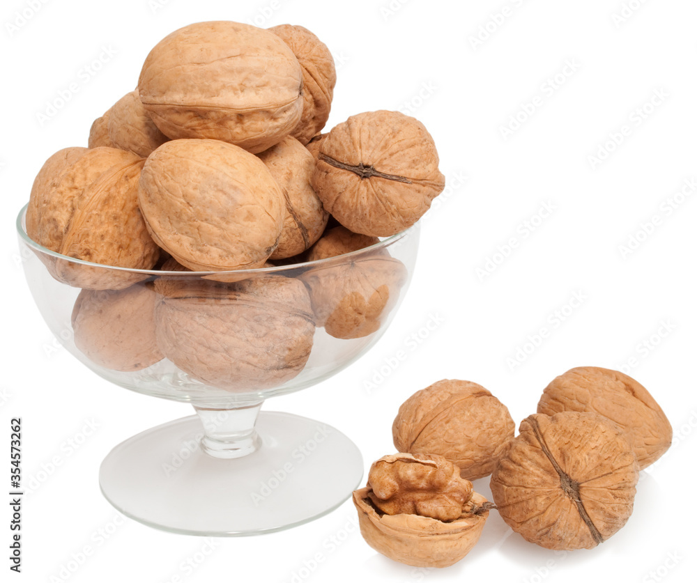 walnuts in a transparent glass bowl isolated on white walnuts in a transparent glass bowl isolated on white