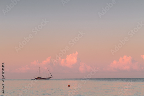 Sailboats on ackground of sunset over sea © horimono