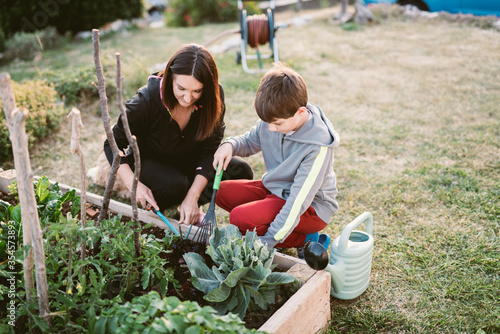 Mother and son in vegetable garden