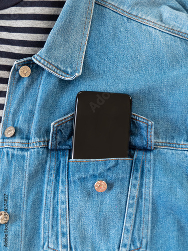 Cellphone in a pocket of jeans jacket