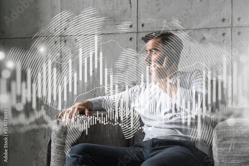 Good looking man in casual wears, talking phone, global financial market issue. Double exposure. The concept of Stock exchange trading. Forex graph hologram.