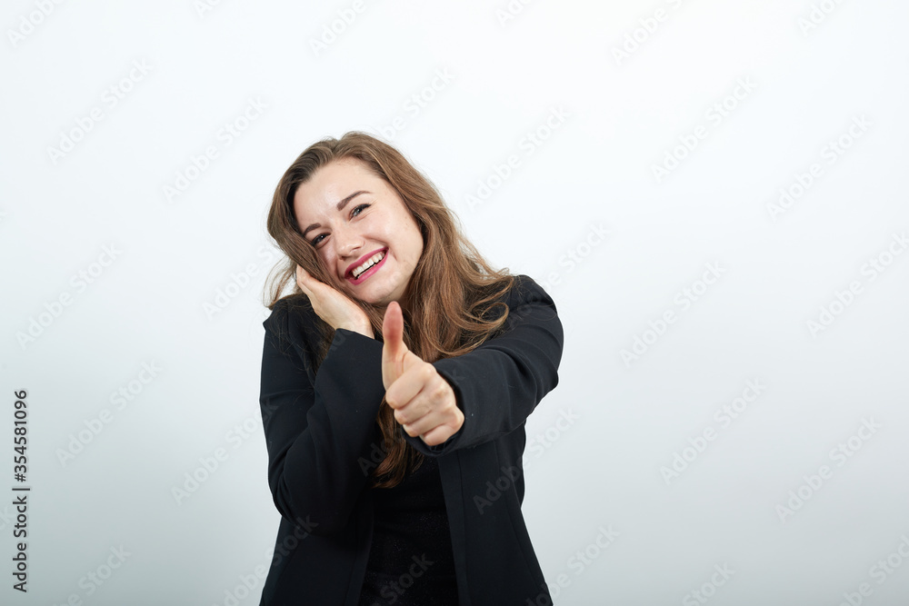showing thumbs up, like sign Positive something good has happened finger gesture for fine result well done, young attractive woman brunette in in a black t-shirt and sweater on white background showing thumbs up, like sign Positive something good has happened finger gesture for fine result well done, young attractive woman brunette in in a black t-shirt and sweater on white background