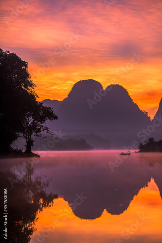 Natural background of a large reservoir in Krabi,Thailand(Nong Thale)atmosphere surrounded by mountains,trees of various sizes, blown through the wind,blurred cool during the day,a viewpoint of travel © bangprik
