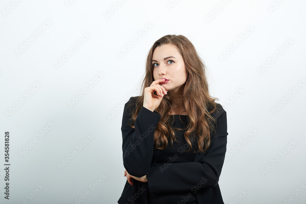 thinking about question, very confused idea hand under her chin making choice, young attractive woman brunette in in a black t-shirt and sweater on white background thinking about question, very confused idea hand under her chin making choice, young attractive woman brunette in in a black t-shirt and sweater on white background
