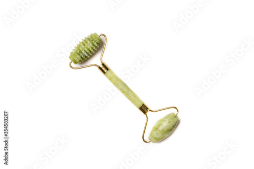 Green jade lifting roller for face massage isolated on white