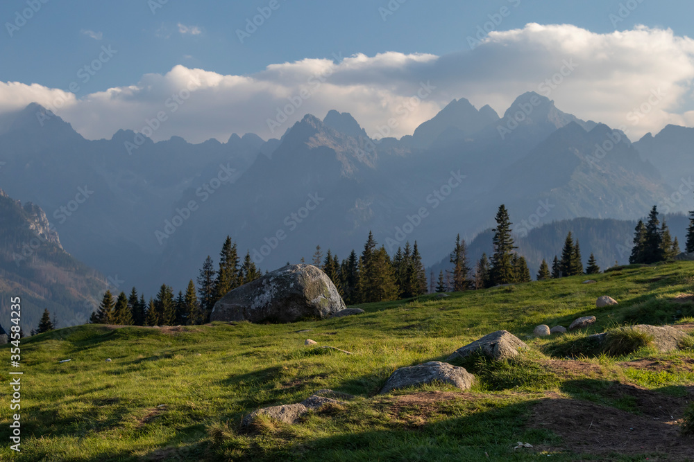 View of the Polish and Slovak Tatras from Rusinowa Polana (Poland). Foggy and cloudy afternoon, popular hiking trail, sheep grazing, viewpoint. View of the Polish and Slovak Tatras from Rusinowa Polana (Poland). Foggy and cloudy afternoon, popular hiking trail, sheep grazing, viewpoint.