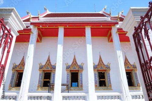 A side view of beautiful white chapel of Wat Poramaiyikawas Worawihan in Koh-Kret,Nonthaburi,Thailand photo