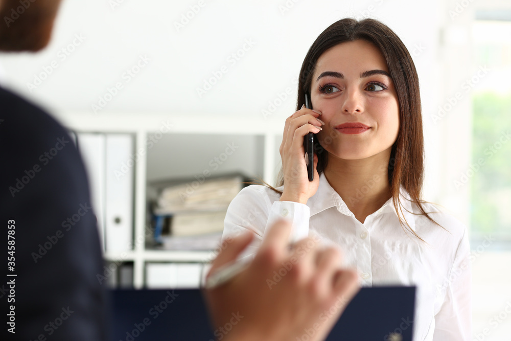 Amazing young project assistant talking per telephone Amazing young project assistant talking per telephone
