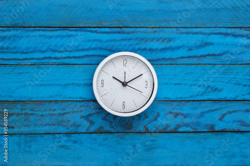 Wallpaper Mural White clock on blue wooden background. Time running away. Top view Torontodigital.ca