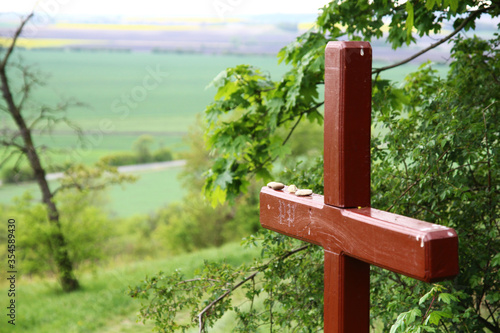 A view from the nature trail of the Chotuc hill (south slope) - natural monument in the Central Bohemian region near Křinec town in the Czech Republic. Brown wooden cross in the foreground. photo