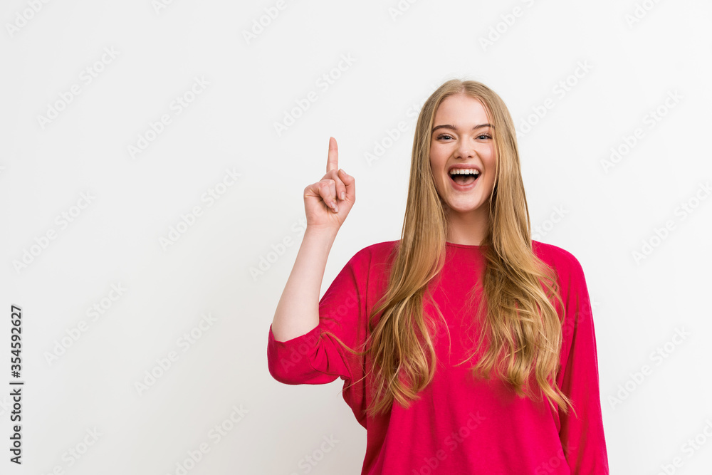 excited girl pointing with finger while having idea isolated on white excited girl pointing with finger while having idea isolated on white