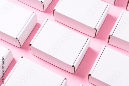Lot of square carton boxes on pink background