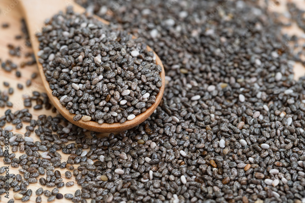 Healthy Chia seeds in a wooden spoon on the table close-up. horizontal Healthy Chia seeds in a wooden spoon on the table close-up. horizontal