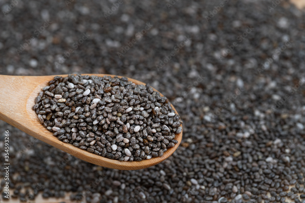 Healthy Chia seeds in a wooden spoon on the table close-up. horizontal Healthy Chia seeds in a wooden spoon on the table close-up. horizontal