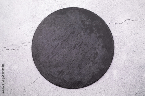 Round slate stand on a gray background