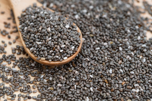 Healthy Chia seeds in a wooden spoon on the table close-up. horizontal