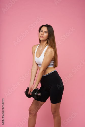  young girl doing fitness on pink background © Paco Sinisterra
