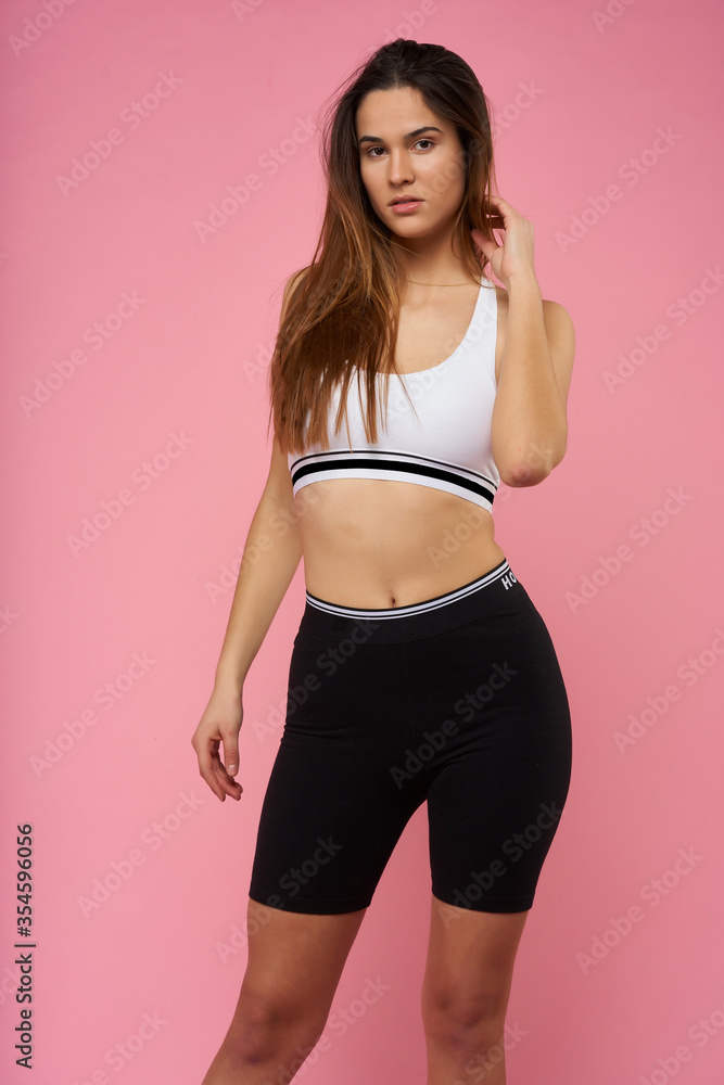 young girl doing fitness on pink background
young girl doing fitness on pink background