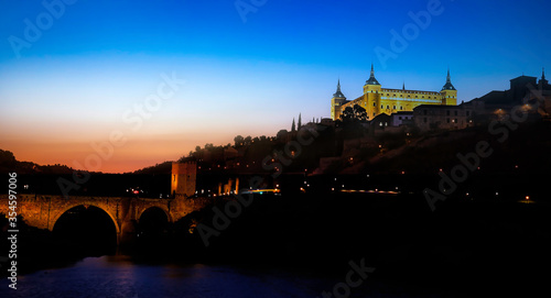 Panorama view in the night of the alcazar above the medieval San Martin bridge - Toledo  Spain