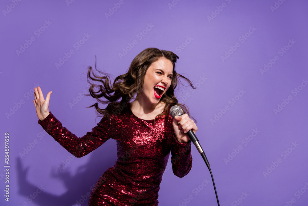Photo of pretty excited cool lady festive party event sing mic favorite song vocalist singer rock song composition wear sequins burgundy dress isolated pastel violet color background Photo of pretty excited cool lady festive party event sing mic favorite song vocalist singer rock song composition wear sequins burgundy dress isolated pastel violet color background