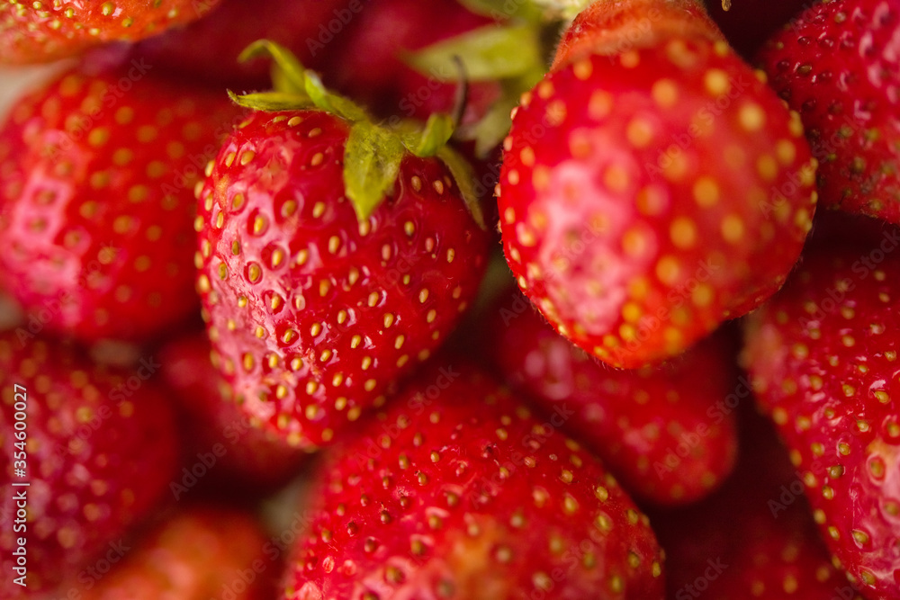 Strawberry. Macro closeup of fresh red and ripe strawberries. Fruit background. Freshly harvested strawberries. Vegetarian vegan organic berries macro. Selective focus Strawberry. Macro closeup of fresh red and ripe strawberries. Fruit background. Freshly harvested strawberries. Vegetarian vegan organic berries macro. Selective focus
