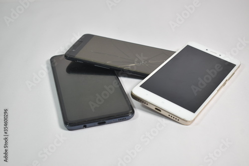 close up of Old broken Mobile phones or cell phones on white background 