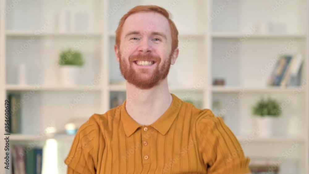 Portrait of Happy Redhead Man Celebrating Win