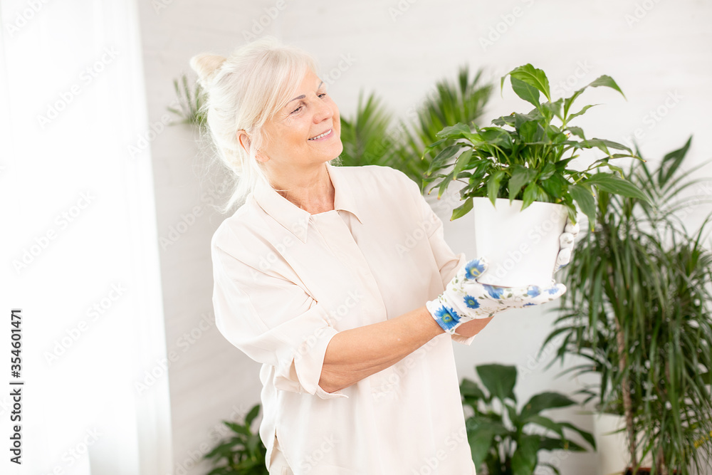Happy smiling woman with green flower in pot. Happy smiling woman with green flower in pot.