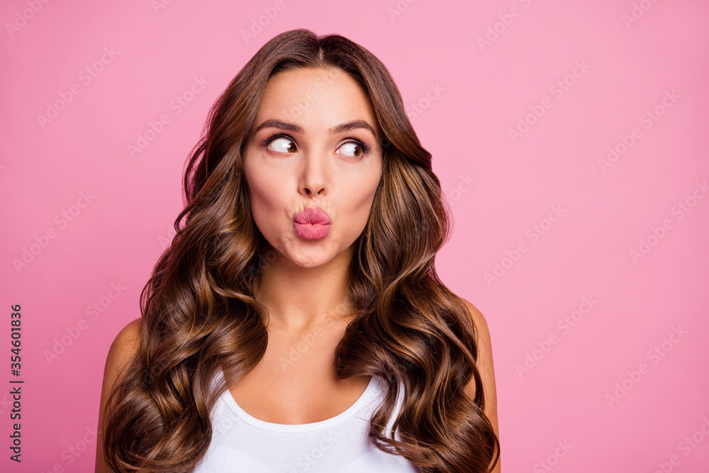 Closeup photo of pretty funny curly lady crazy facial expression sending air kisses look interested side empty space wear white casual singlet isolated bright pink color background Closeup photo of pretty funny curly lady crazy facial expression sending air kisses look interested side empty space wear white casual singlet isolated bright pink color background