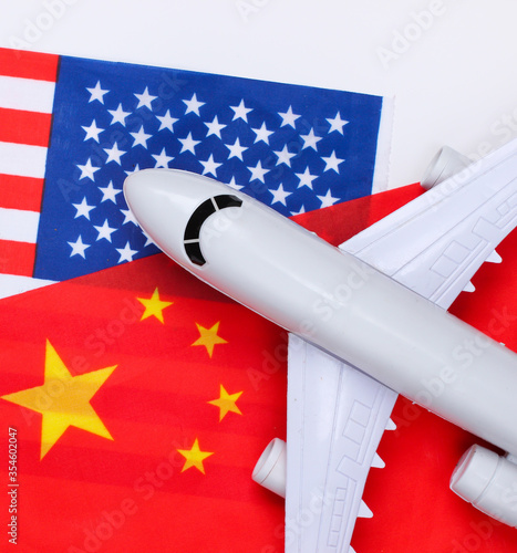 Air flight between countries. Figurine of airplane with the flag of China and the USA. Air travel