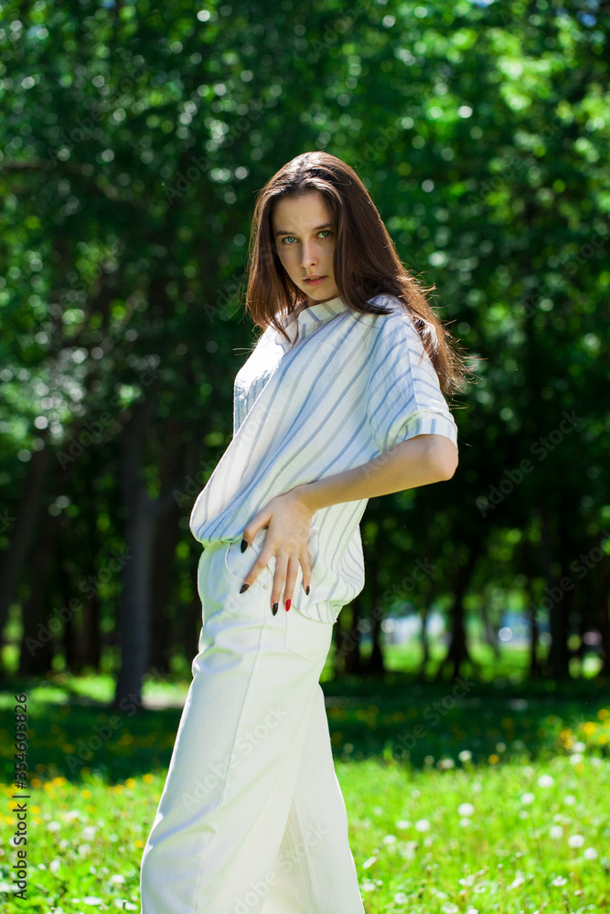 Portrait of a young beautiful brunette girl in summer park Portrait of a young beautiful brunette girl in summer park