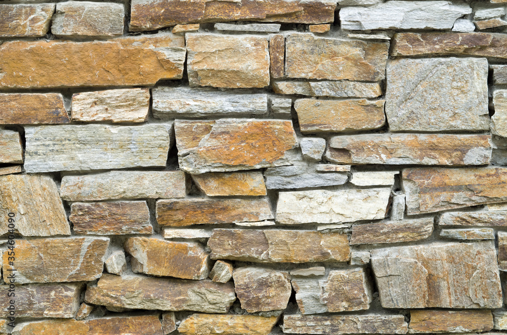 Fototapeta premium Old colorful stone wall closeup
