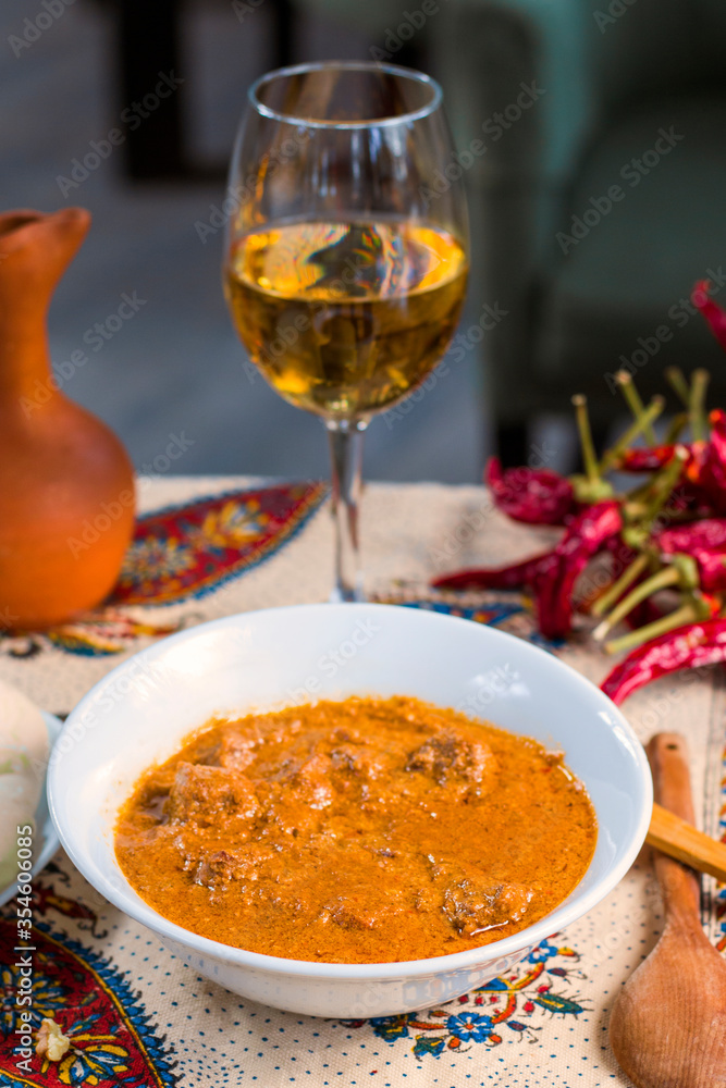 Φωτογραφία Georgian traditional food soup Kharcho or walnuts souse with beef meal, dry red pepper, tomatoes and other ingredients