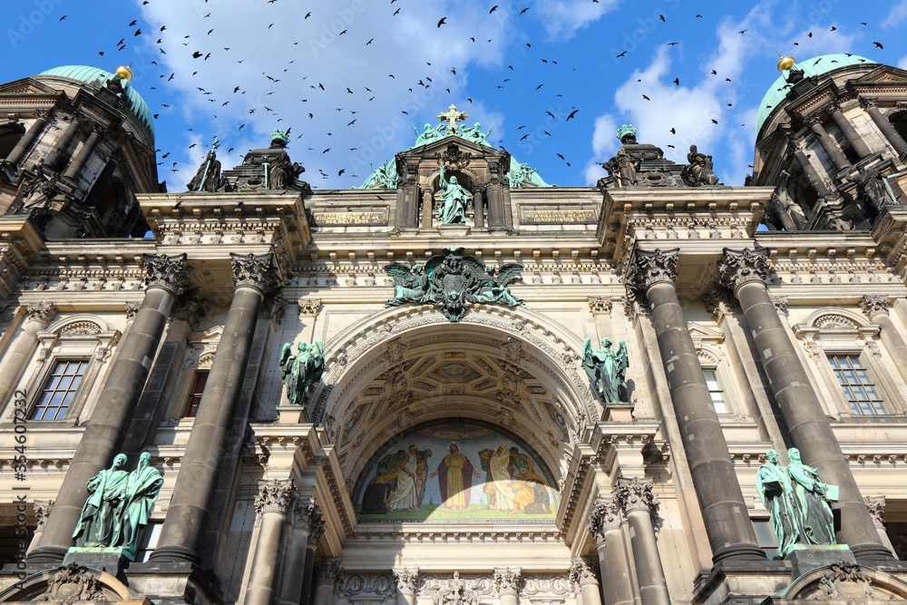 Berlin Cathedral. Black birds flock over city.